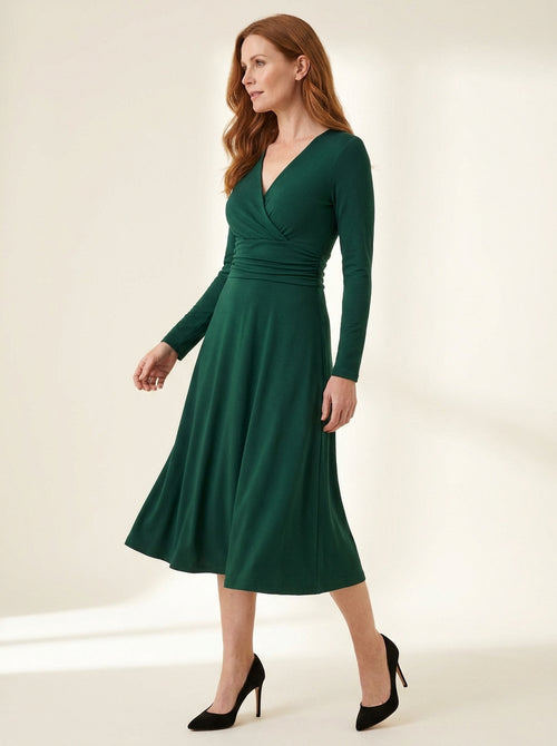 emerald green long sleeve midi dress with softly ruched waist — angle view