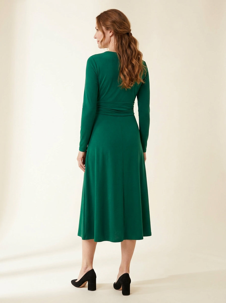 emerald green long sleeve midi dress with softly ruched waist — back view